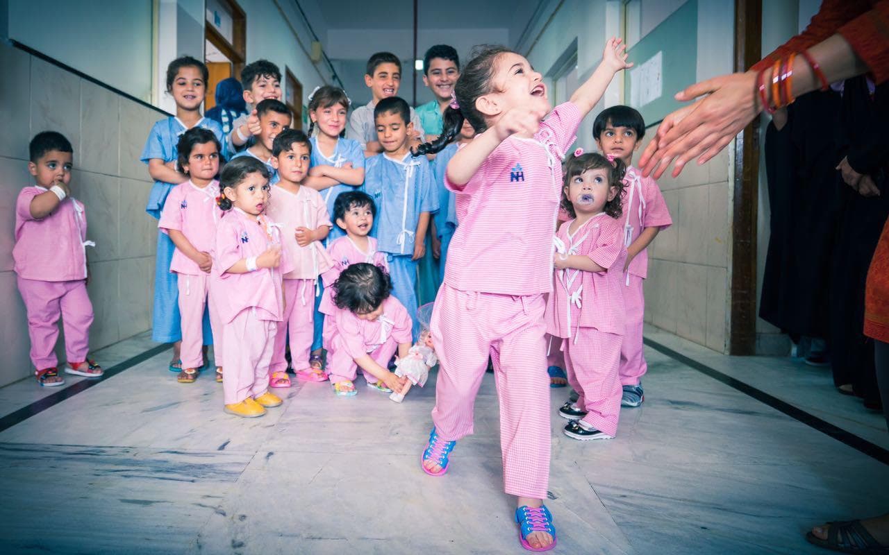 Iraqi children in hospital gowns in a corridor at Narayana Health City, Bangalore
